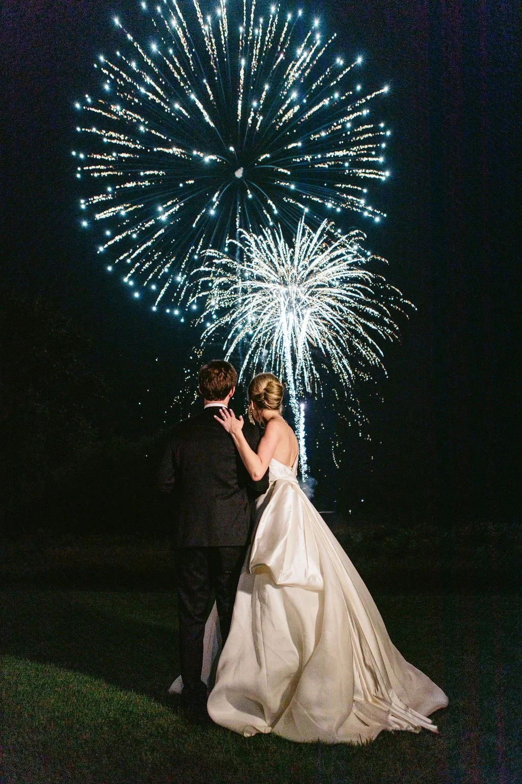 firework show with bride and groom