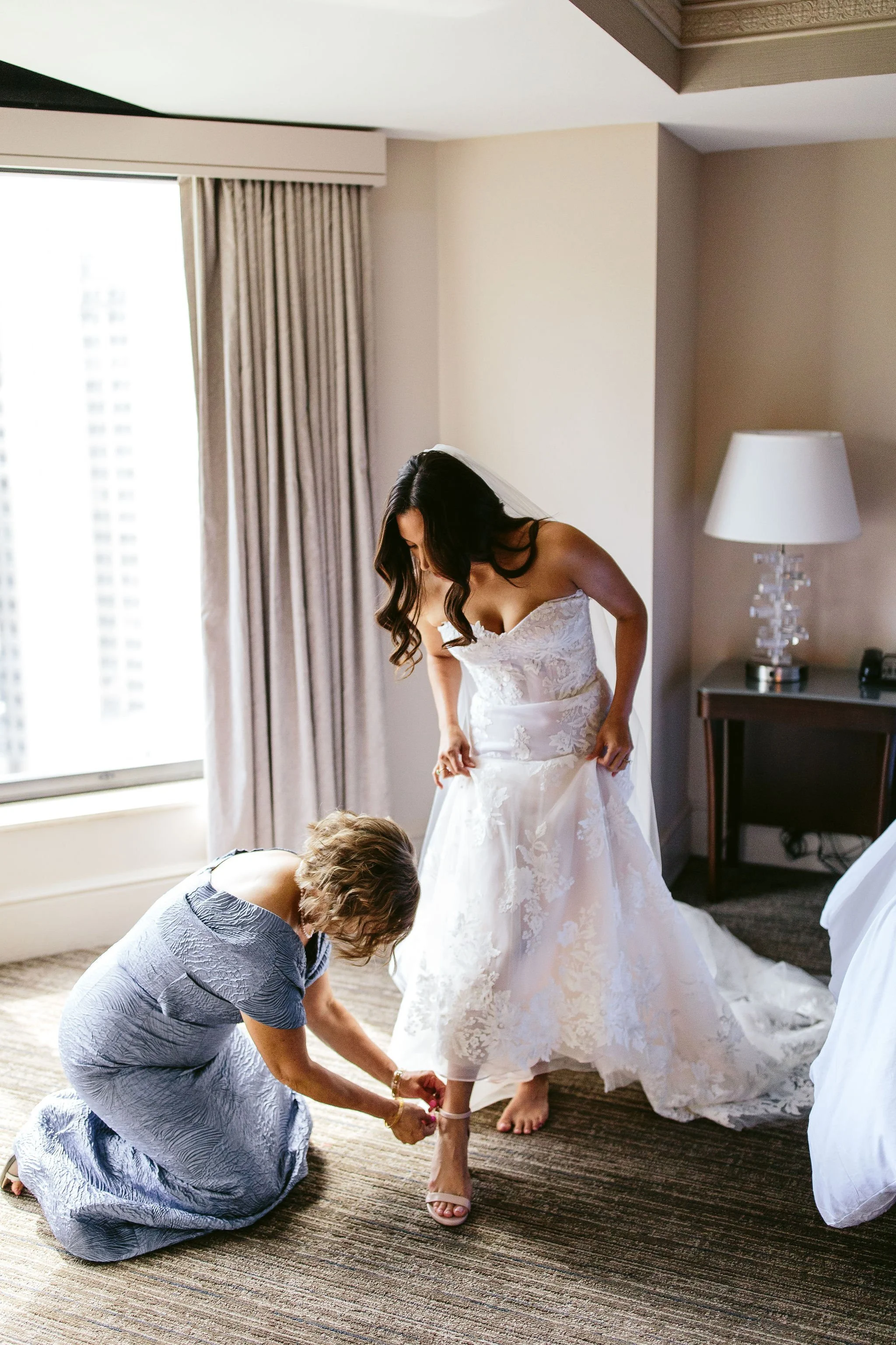 bride putting on shoes at chicago wedding