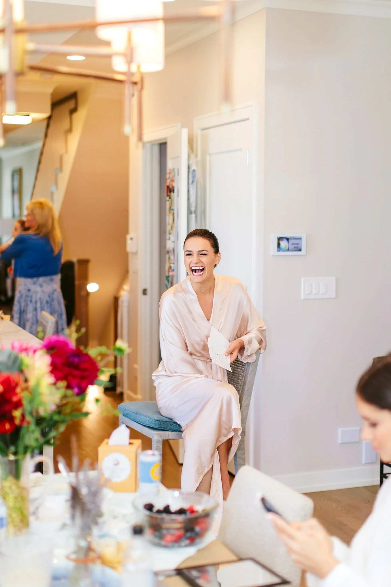 bride laughing in makeup chair
