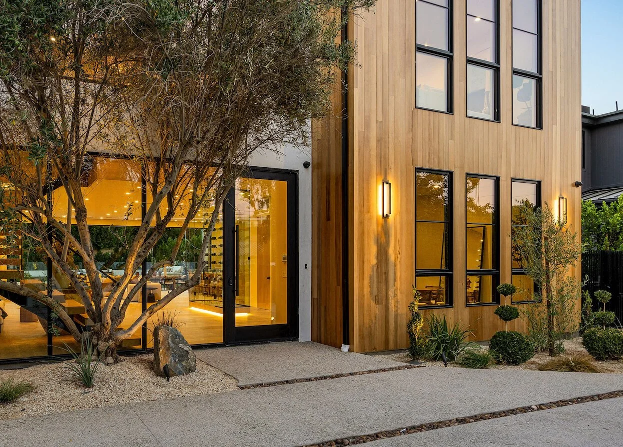 exterior of a luxury home in the evening time highlighting architectural lighting design