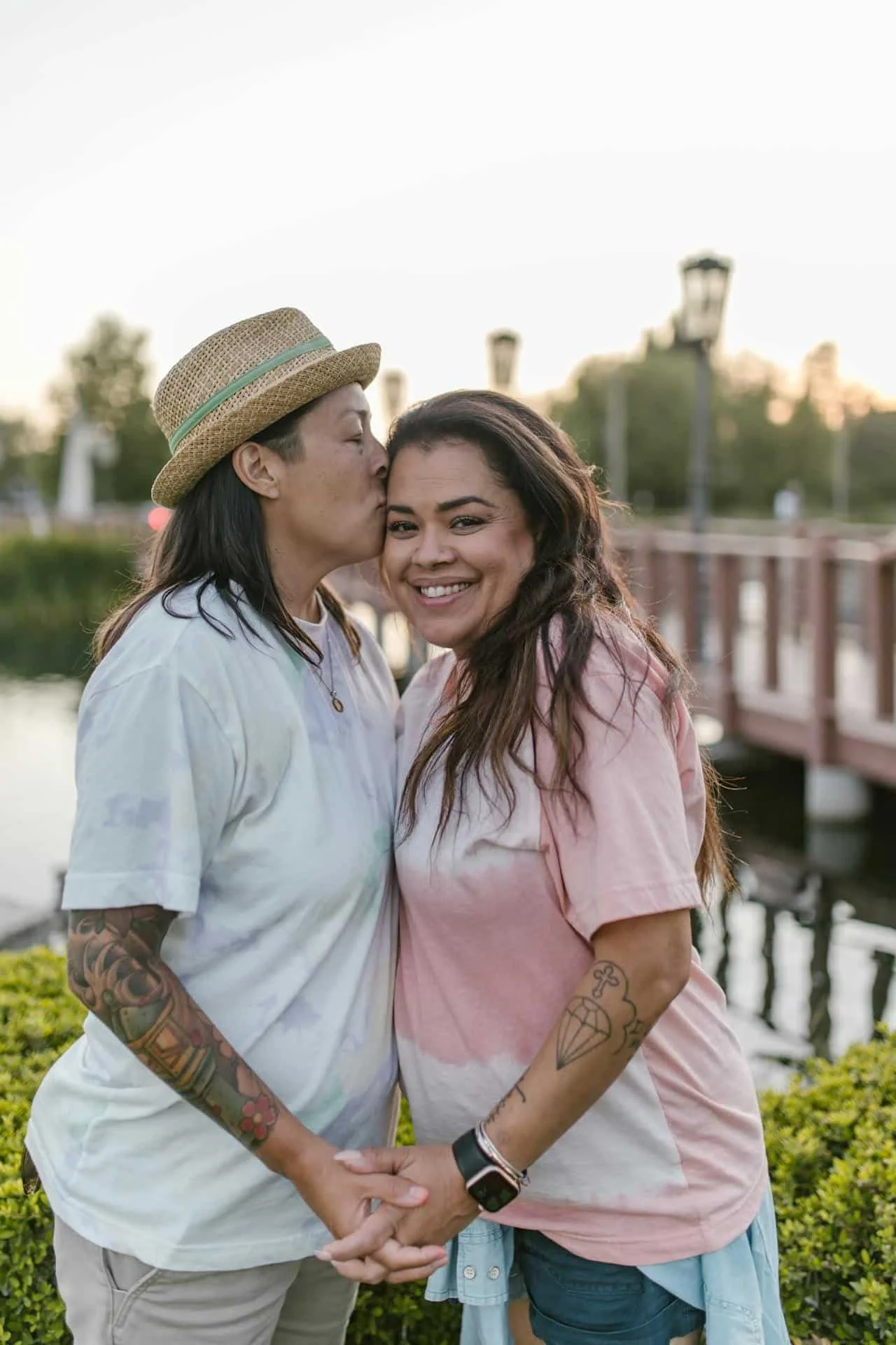 two women, one kissing the others forehead