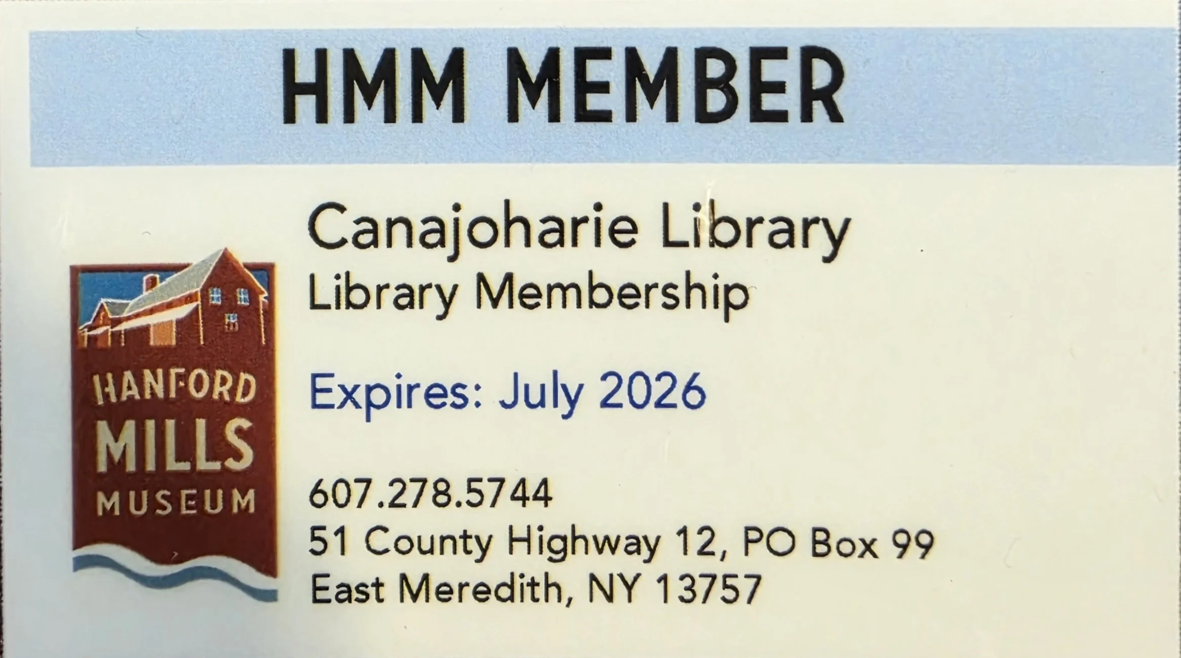 This is an image of the Hanford Mills Museum pass. It has our membership details and the hanford mills museum logo (their business name on a brick red ribbon and house)