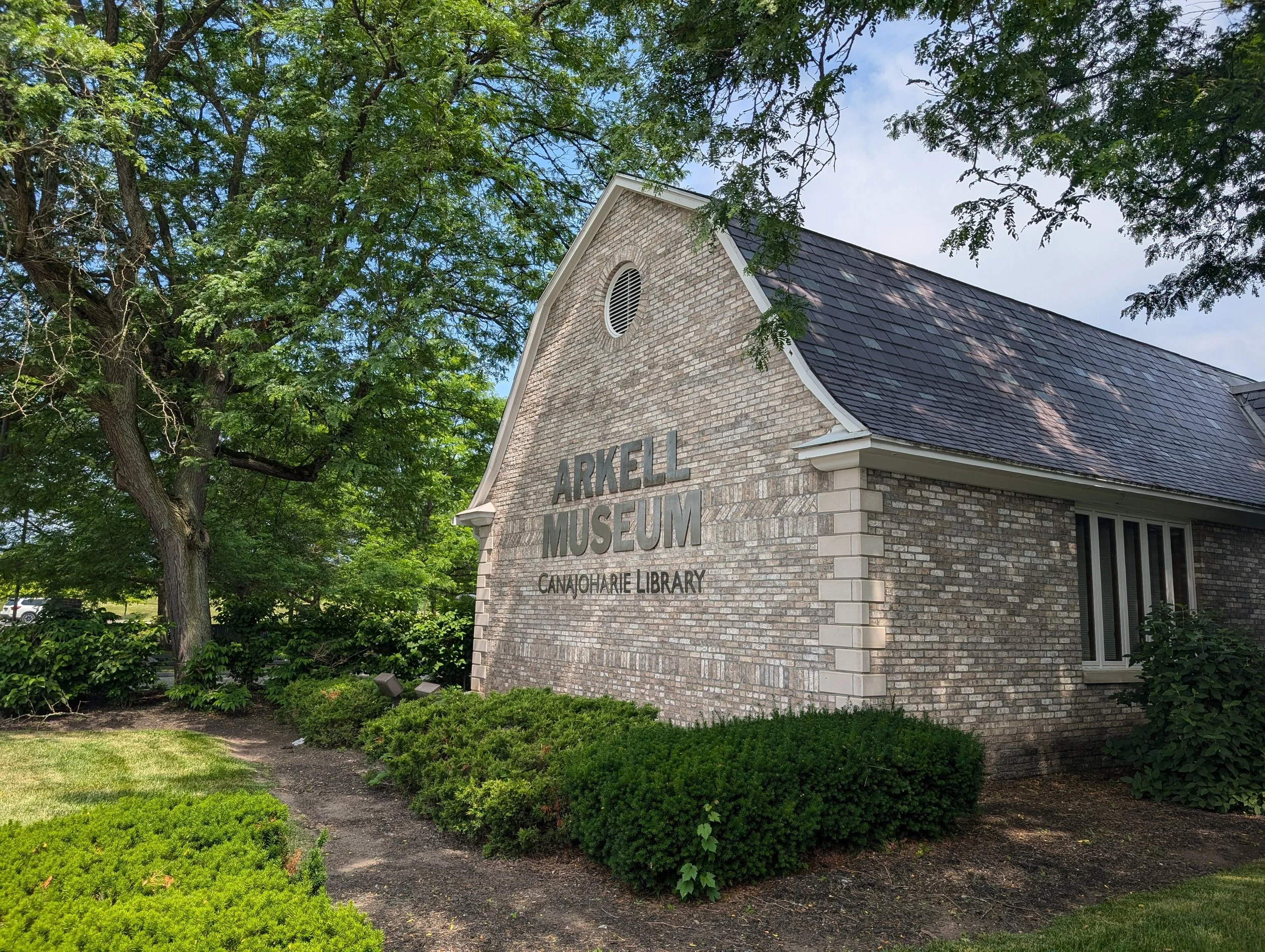 Gable end of a stone building with sign that reads: Arkell Museum Canajoharie Library