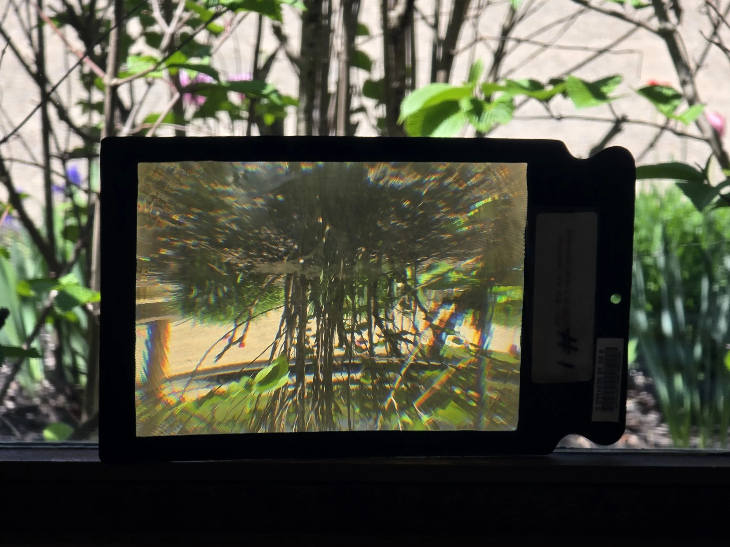 This is a photo of our page magnifier. It is propped up on the window to show a clear screen and demonstrate it's magnification of the garden just outside the window.