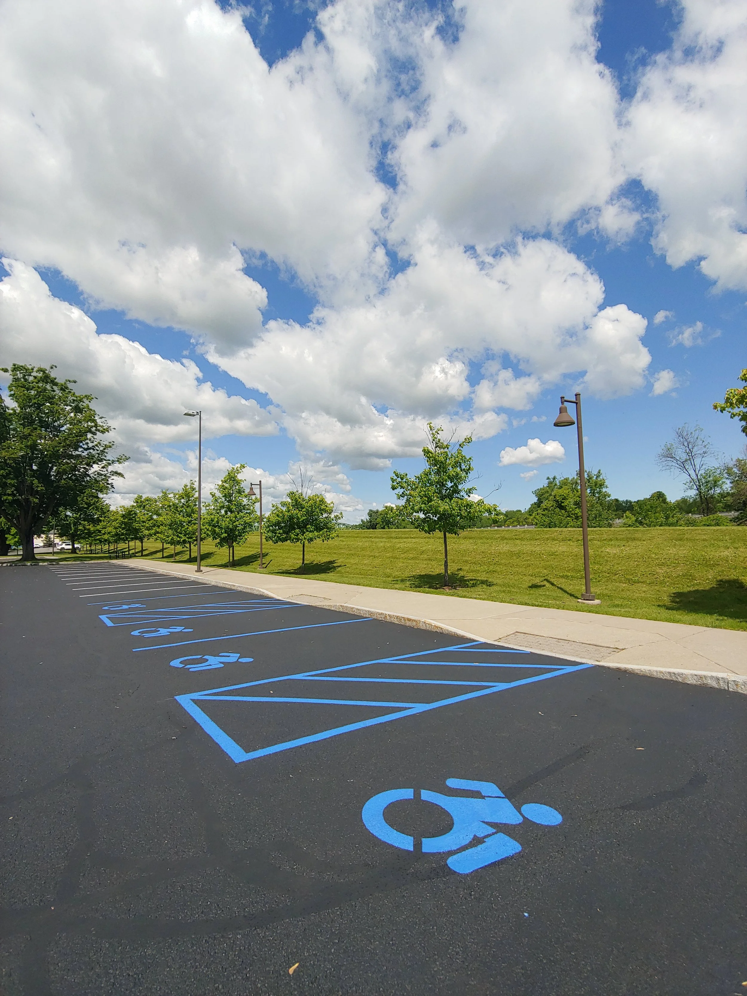 Photo of part of a parking lot with blue markings showing handicap parking spots