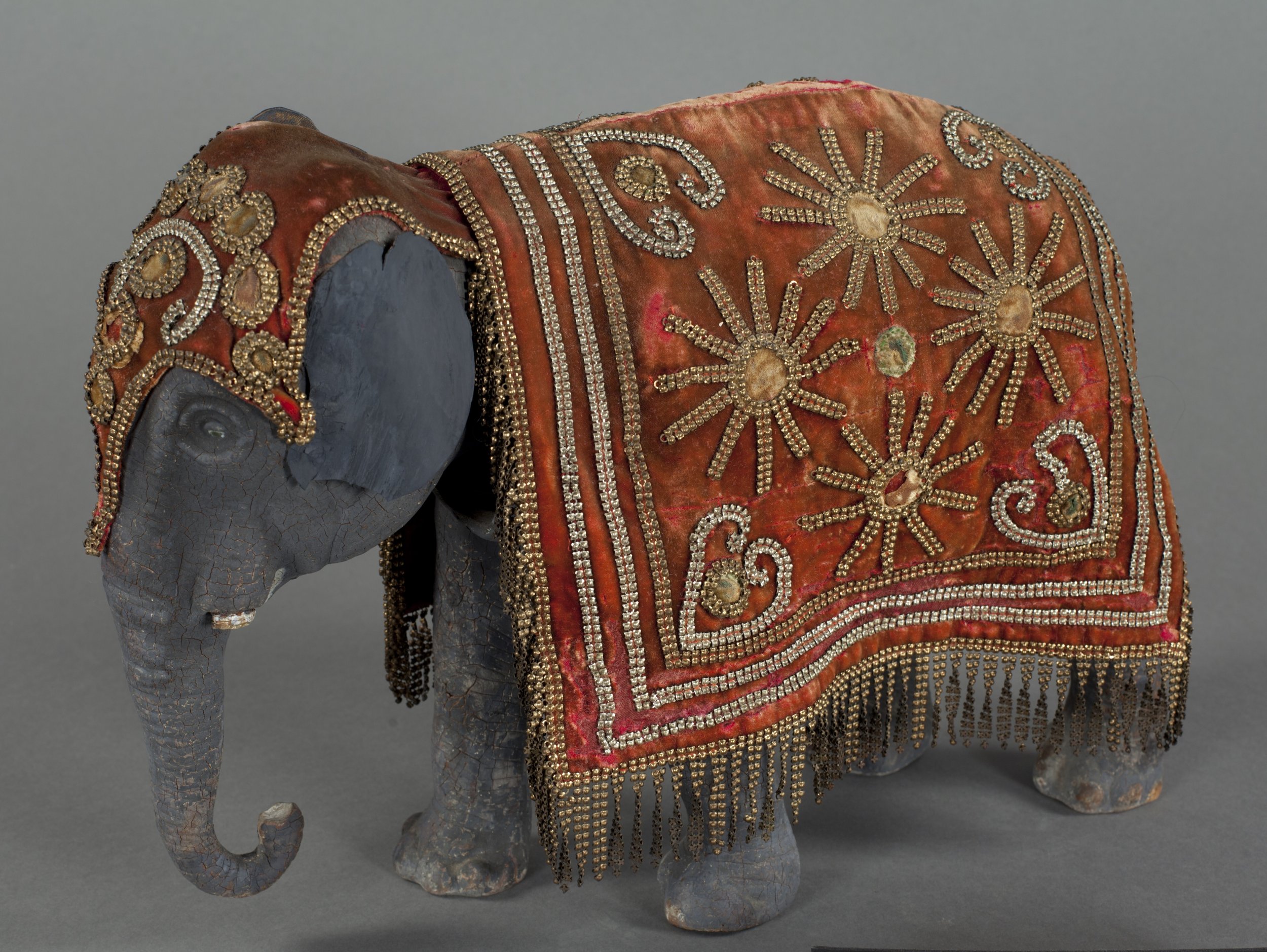 statue of an elephant with an ornate headdress and  blanket.