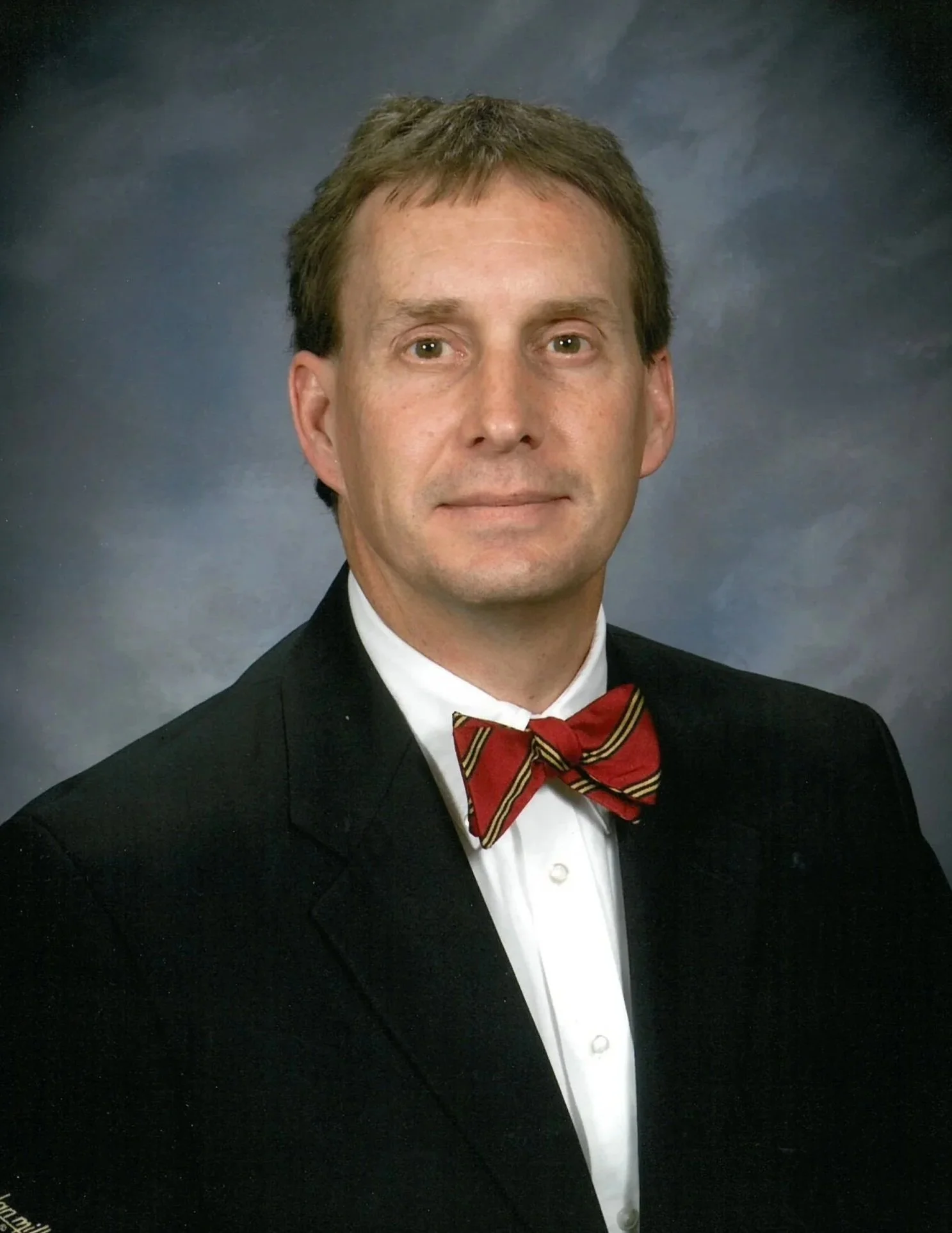 This is a photo of board treasurer Nathan Fenno. He is an older gentleman wearing a suit and a red bowtie.