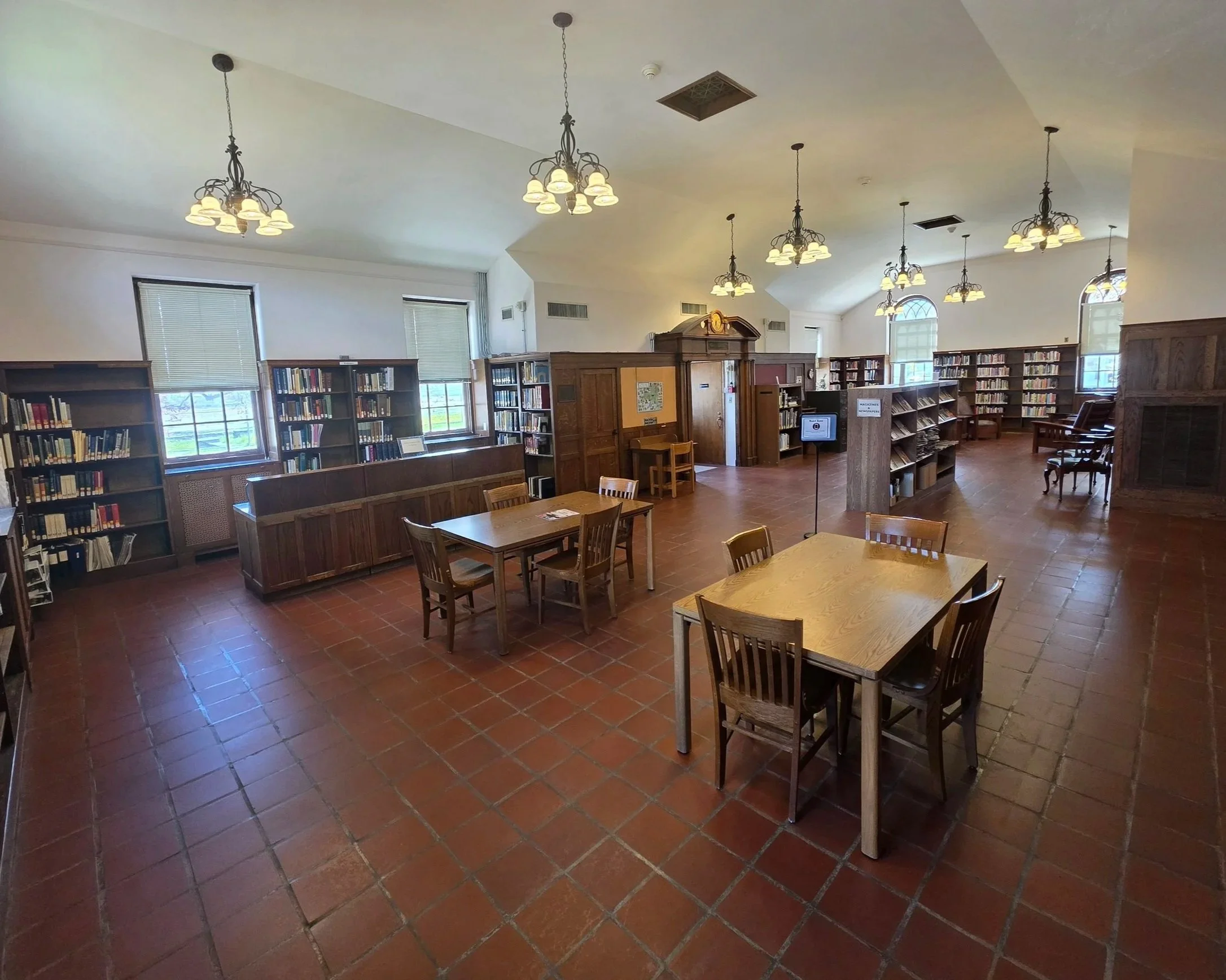 The Canajoharie Library opened “for the loaning of books” on September 28, 1925. Built from the This is a photo of the original Library building that now serves as our Reading Room. You can see chandeliers lighting the two tables and chairs below.