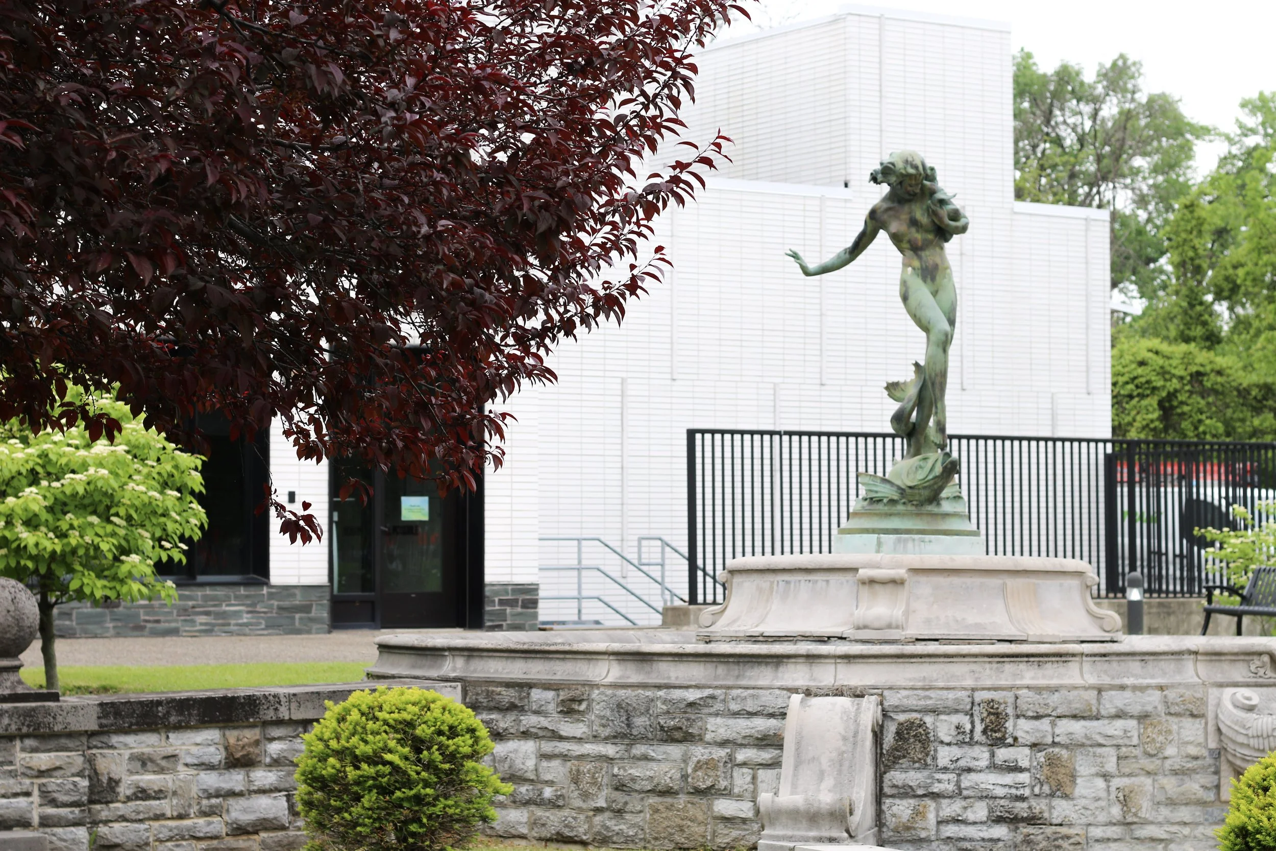 This is an image of the Memorial Garden and Harriet Frishmuth's statue Humoresque (a nude woman modeled after a dancer, balancing on a fish)