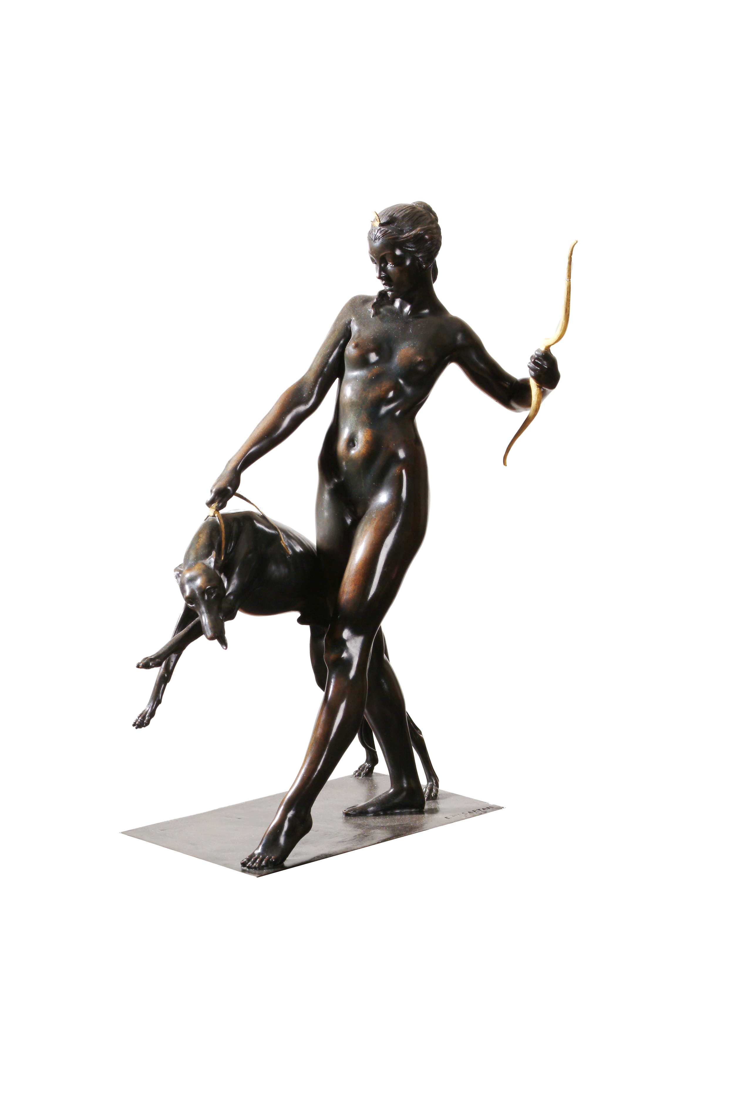 Bronze statue of the goddess Diana. This is a sleek nude sculpture. The woman stands restraining a large hound. 