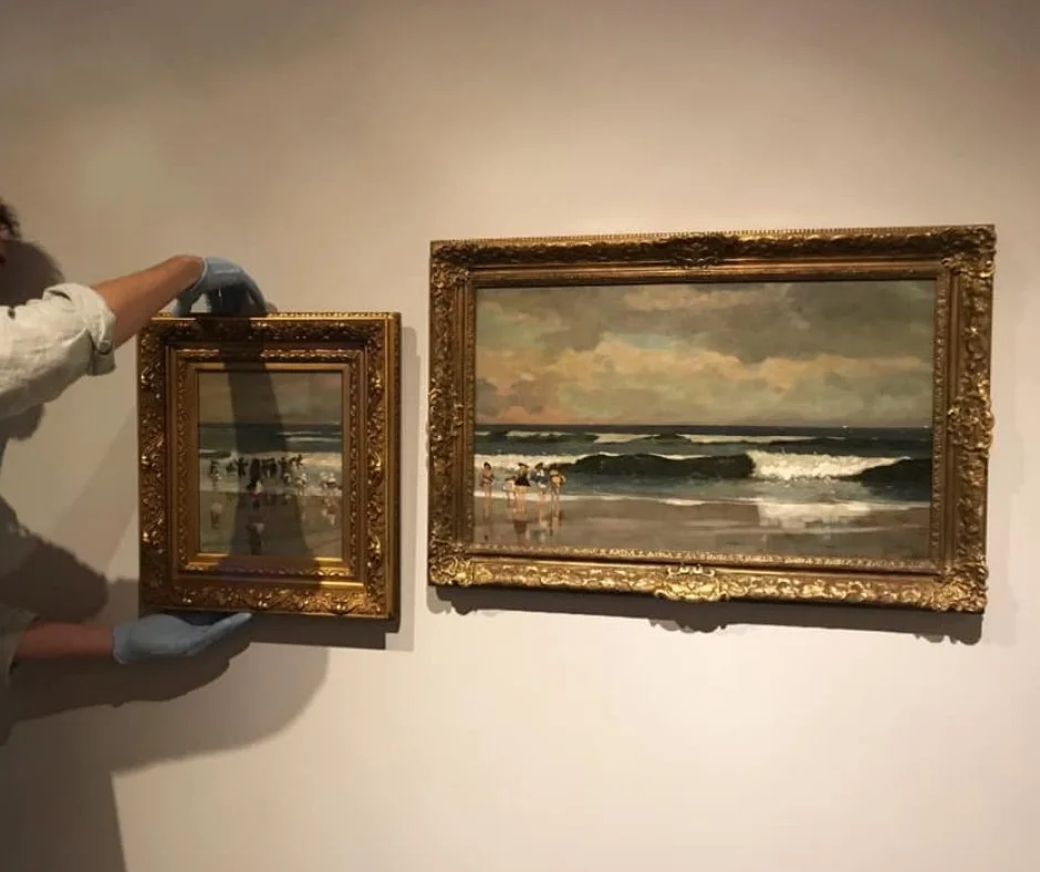 Photograph of two beach scenes hanging next to each other