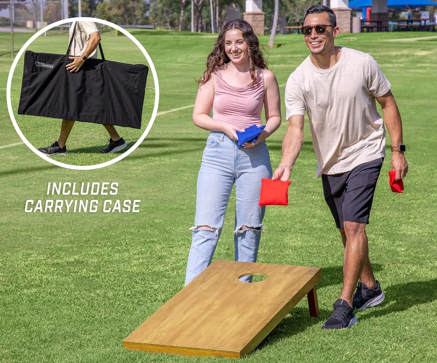 This is an image of a man and woman playing Cornhole. They are each carrying their respective color bean bags for the game; The woman is holding blue and the man red. It also shows the carrying case included in the kit.