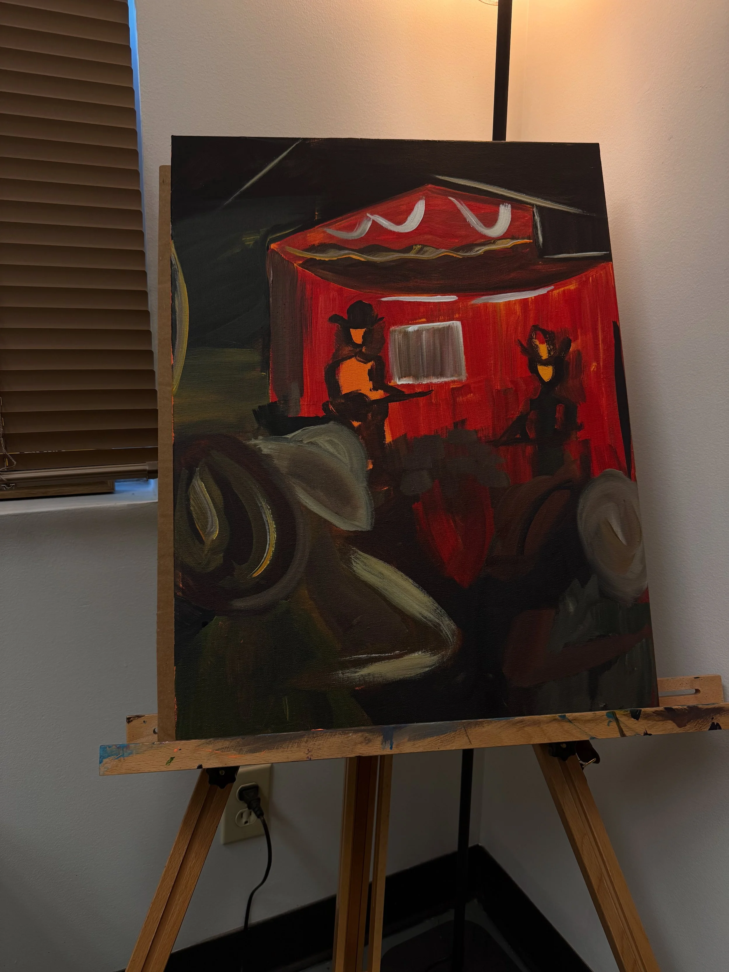 An abstract painting on an easel depicting two figures sitting in front of a red background, with some white and yellow accents, and a black background above.
