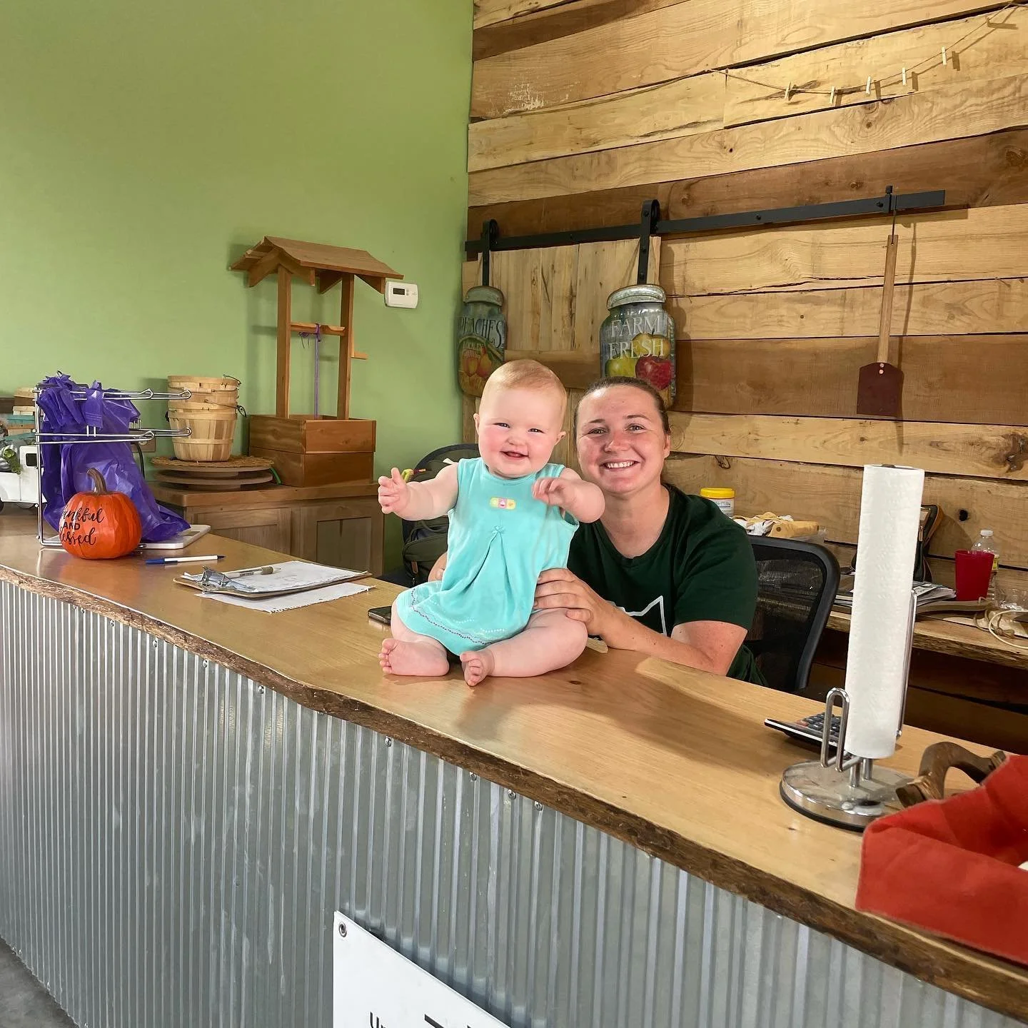 Suzie Ebenhack and her child at the farm market.