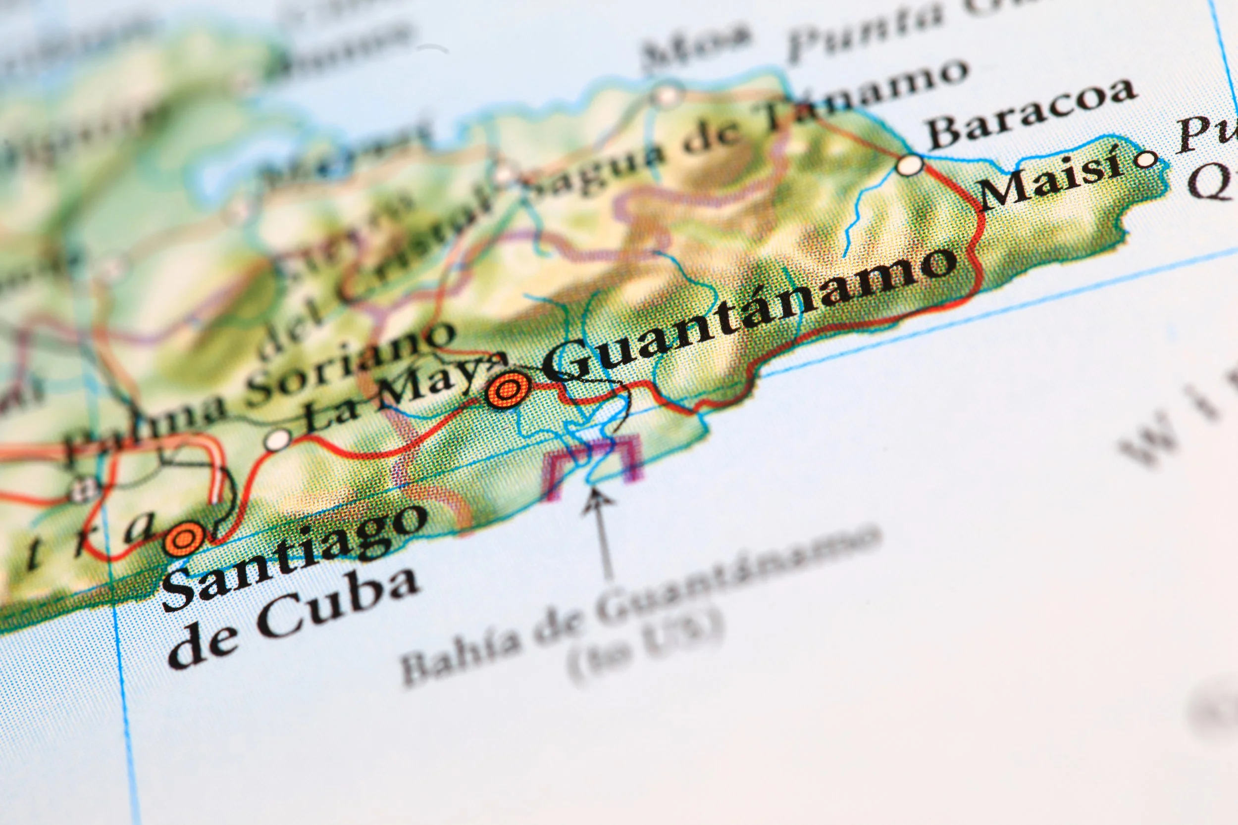A detailed map of Cuba highlighting the southern coast including Santiago de Cuba, Guantánamo, and Maisí, with blue lines representing water bodies and various routes marked across the island.