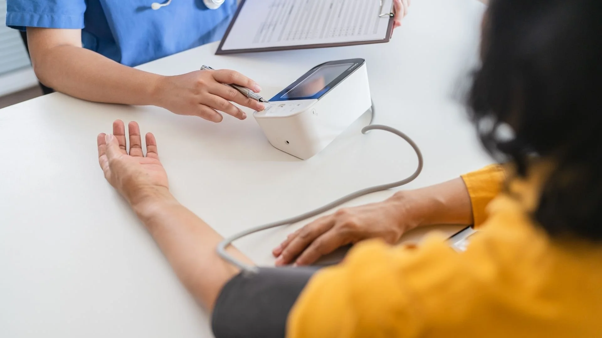 Medical provider running blood pressure test on a patient