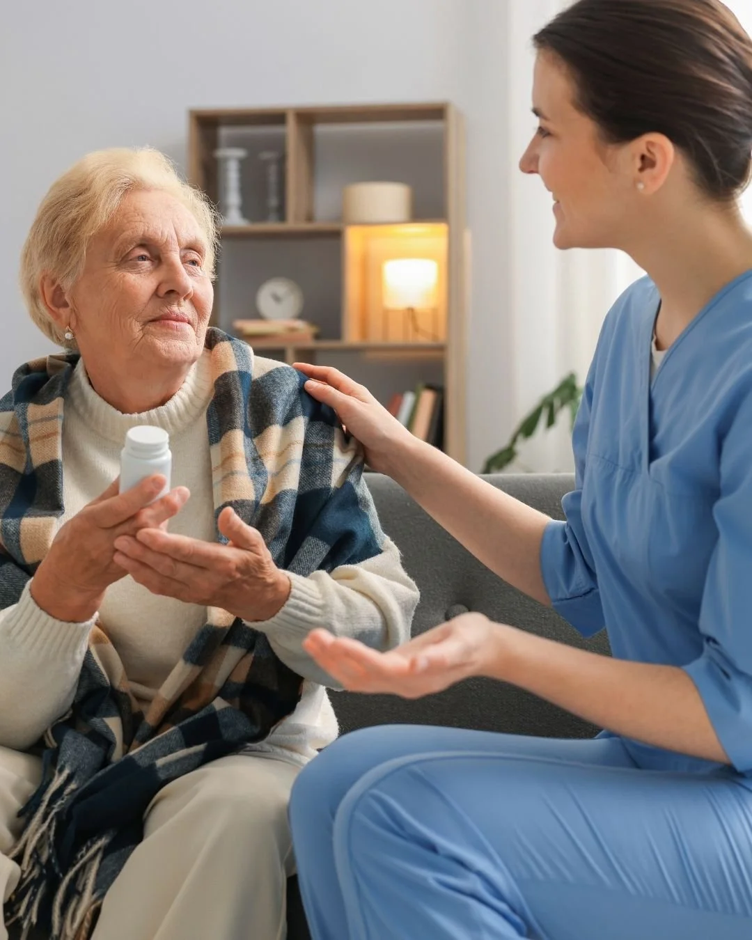 Elderly woman holding a bottle of medicine with a medical provider explaining the routine