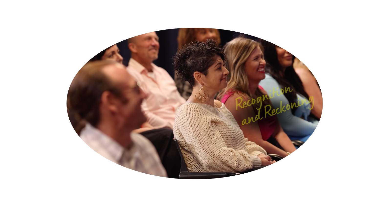 People attending a seminar or conference, seated and listening attentively; text overlay reads "Recognition and Redefining."