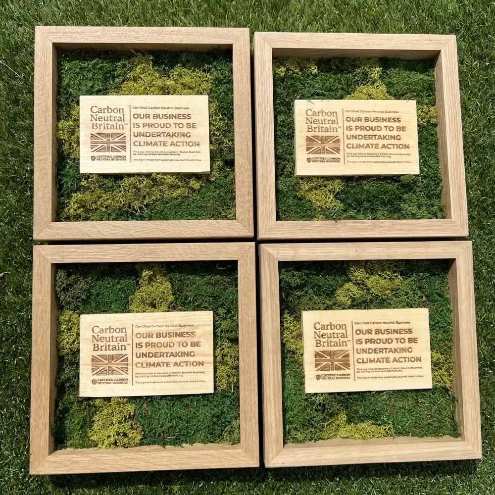 our Carbon Neutral Britain preserved moss pieces with engraved wooden plaques in oak frames.