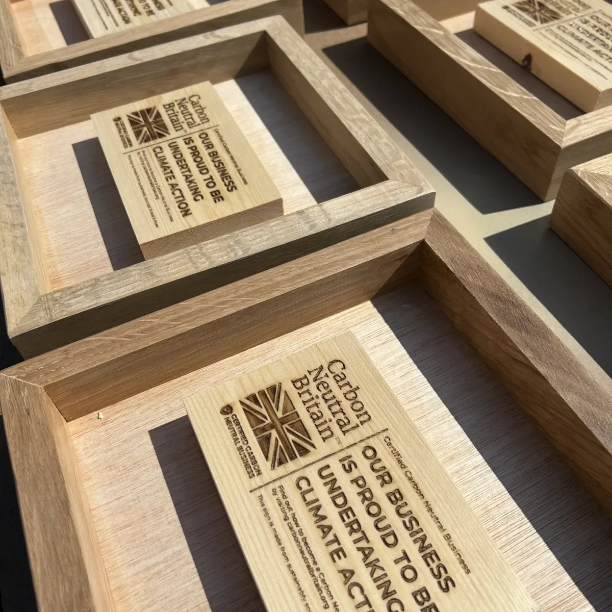 Oak frames and engraved Carbon Neutral Britain plaques during assembly.