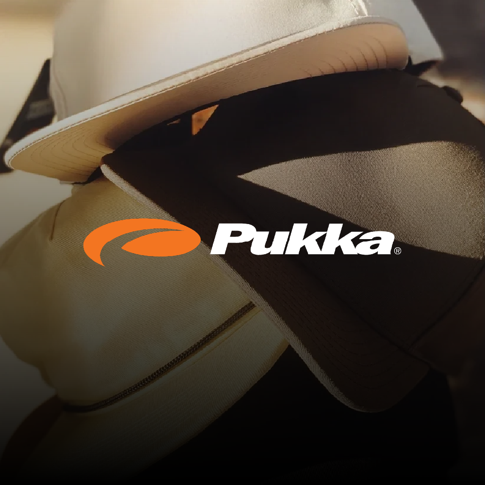 Close-up of a hat resting on a backpack or bag, with a Pukka logo placed over the image.