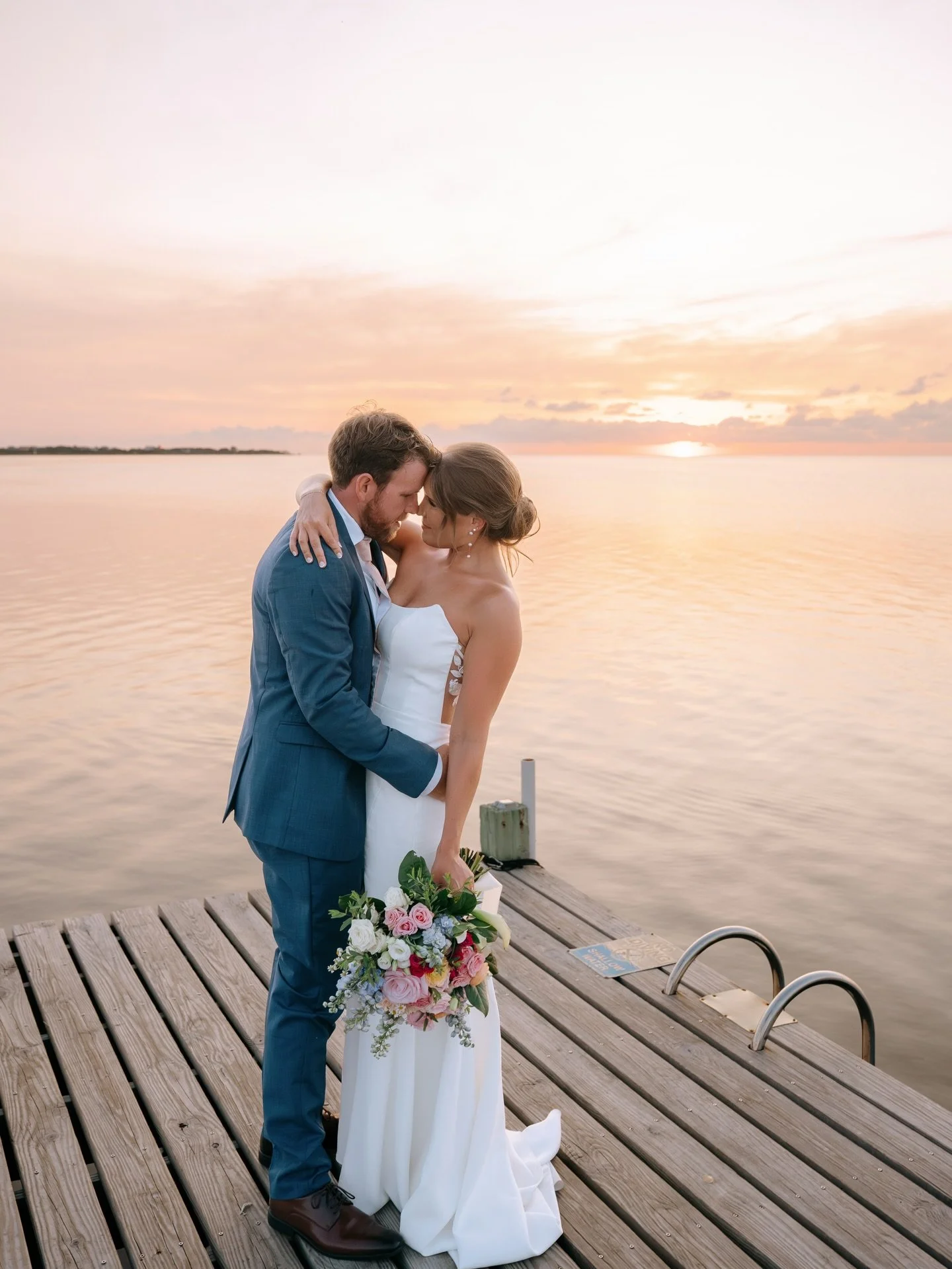 Amy was breathtaking in her @urbansetbride gown on the waters of OBX at the @innonpamlicosound 

Perfectly captured by @katieludolphphotos 

Gown by @palomablancabridal 
Beauty @glimmerhairandmakeup 
Florals @flowergirlsobx