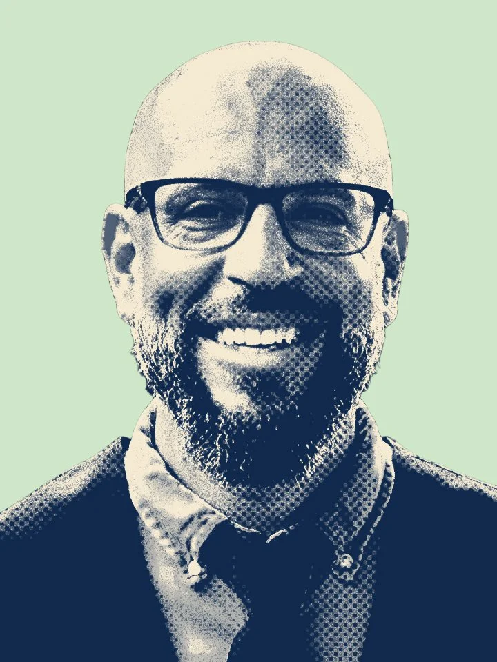 Stylized illustration of a smiling man with glasses, a bald head, and a beard, wearing a collared shirt and jacket, against a light green background.