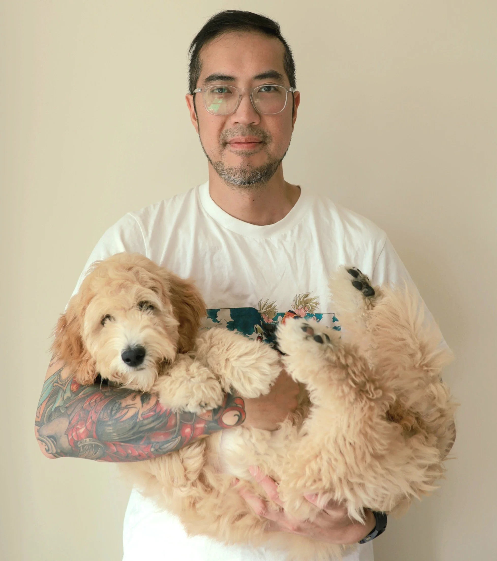 Ray Kwok, Toronto wedding videographer, holding his dog and smiling