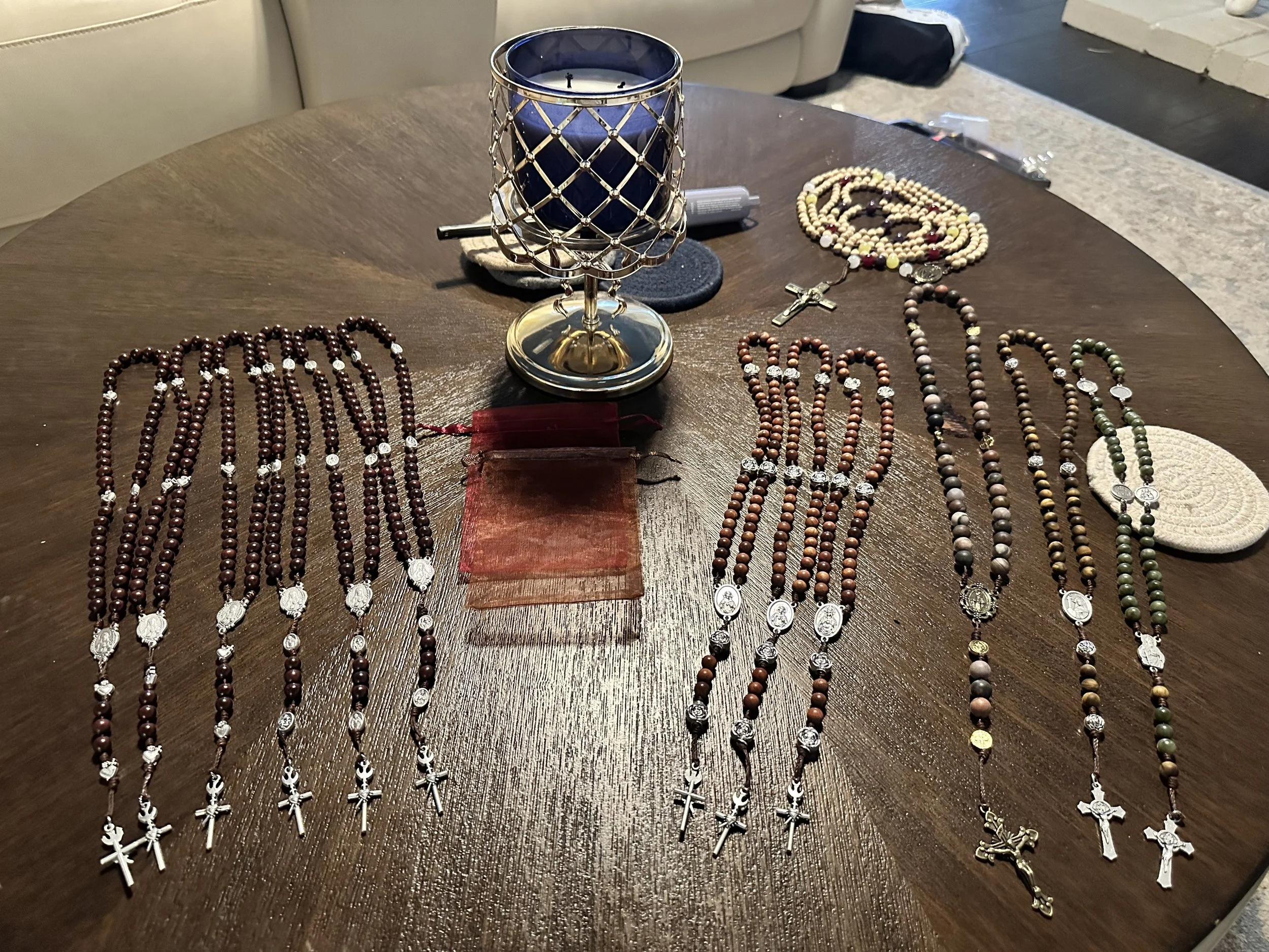 Display of multiple catholic rosary beads with crosses.