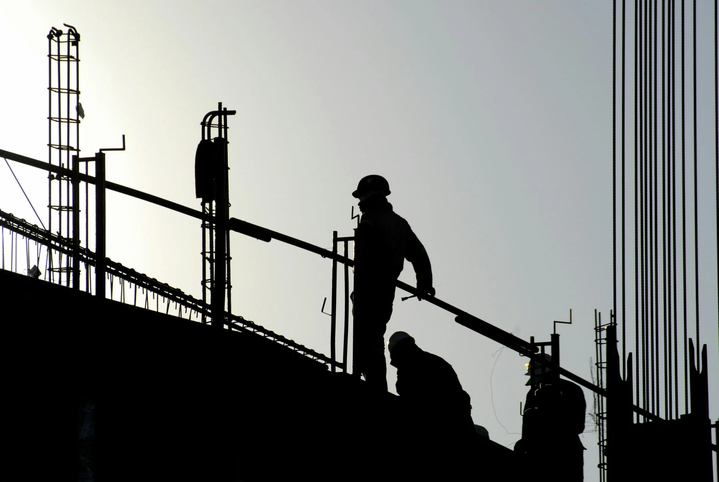 Construction workers on a job site — workplace safety compliance solutions