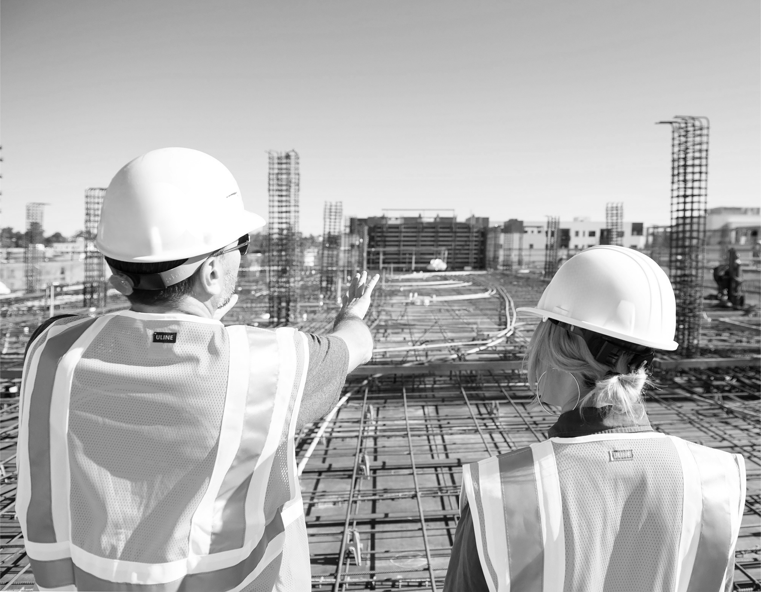 Safety workers overseeing an active construction site — hands-on compliance consulting