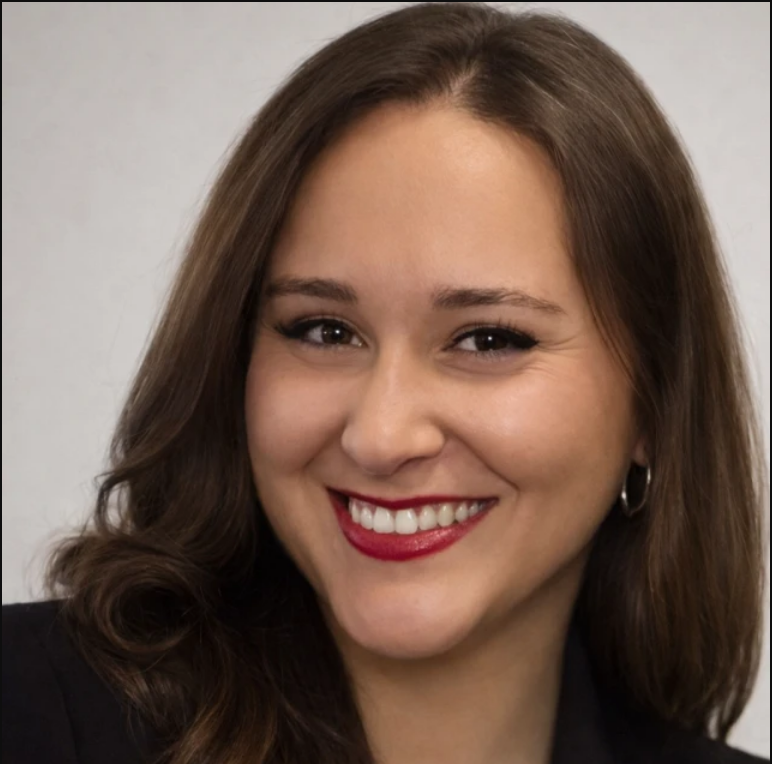 Smiling woman with brown hair, red lipstick, and hoop earrings.