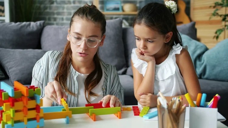 woman and child buidling with blocks
