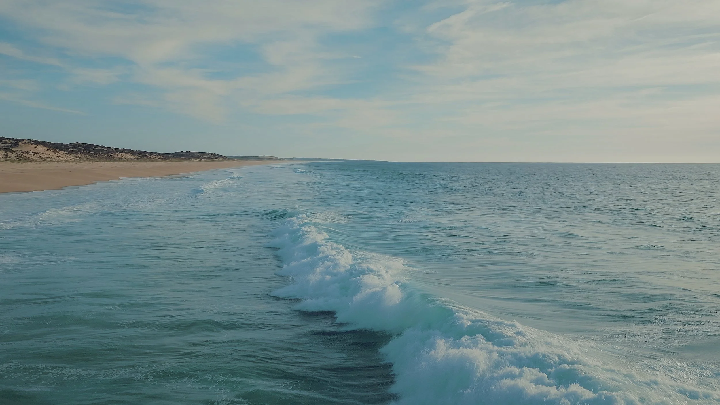 blue-ocean-waves-moving-towards-the-coastline-on-a-sunny-summer-day-seaside-scenery-an-SBI-350885547.jpg
