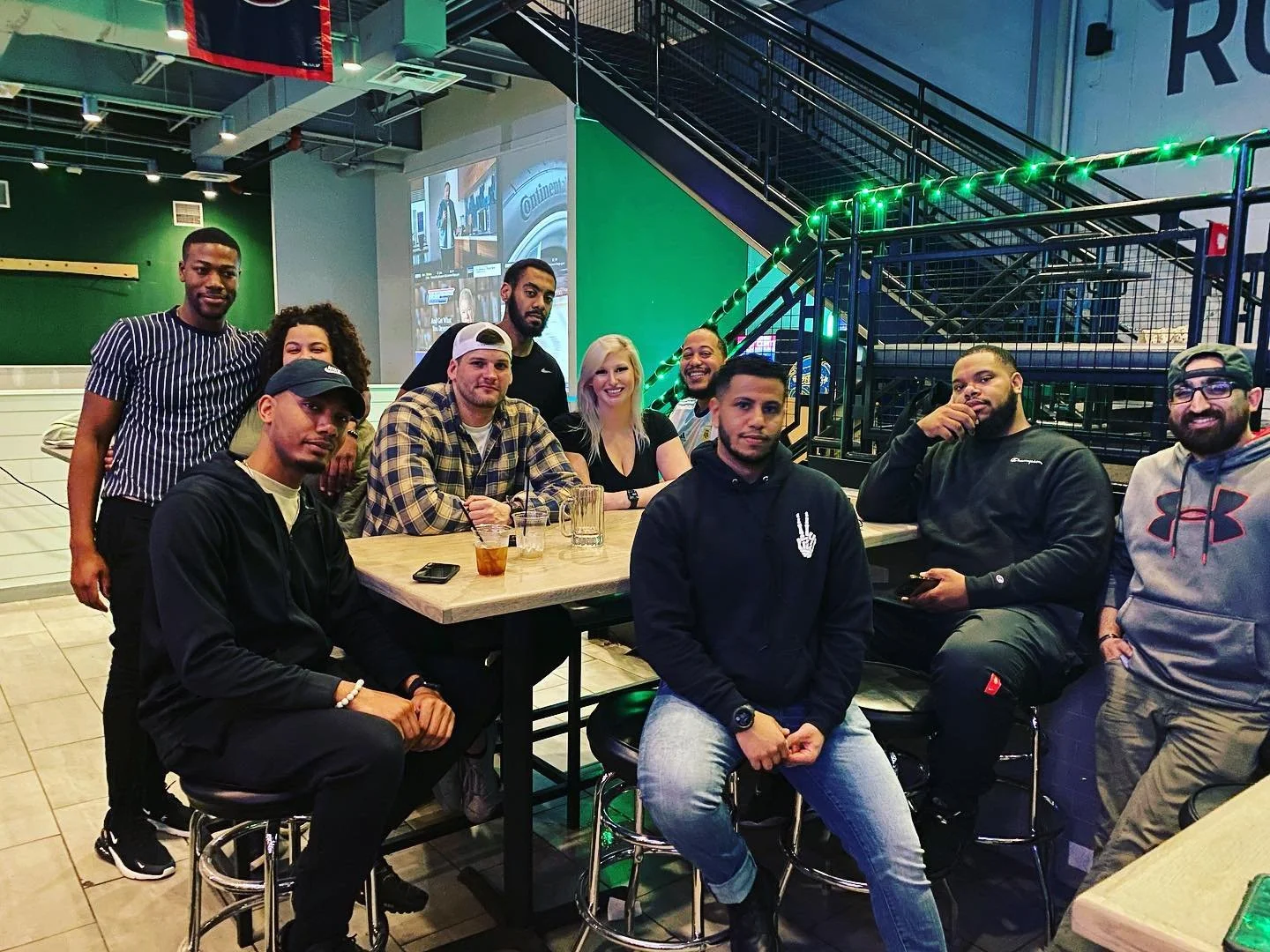 Group of off‑duty officers and friends relaxing together at a restaurant, representing the National First Responder Peer Support Network from Badges and Breakthroughs—real people, real connection, and support beyond the uniform.