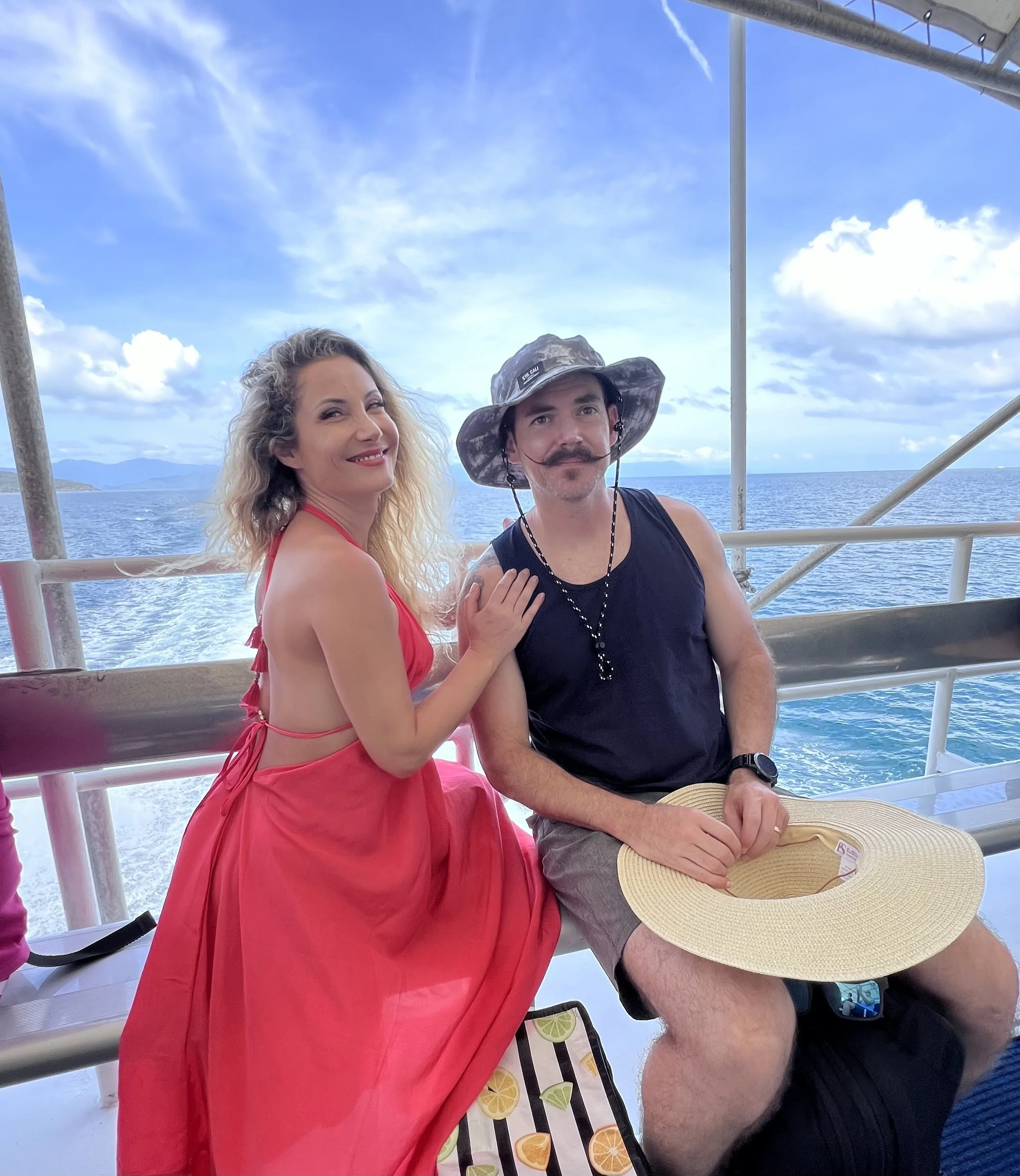 Couple on the ferry from Cairns to Fitzroy Island in Queensland, Australia with views of the Coral Sea.