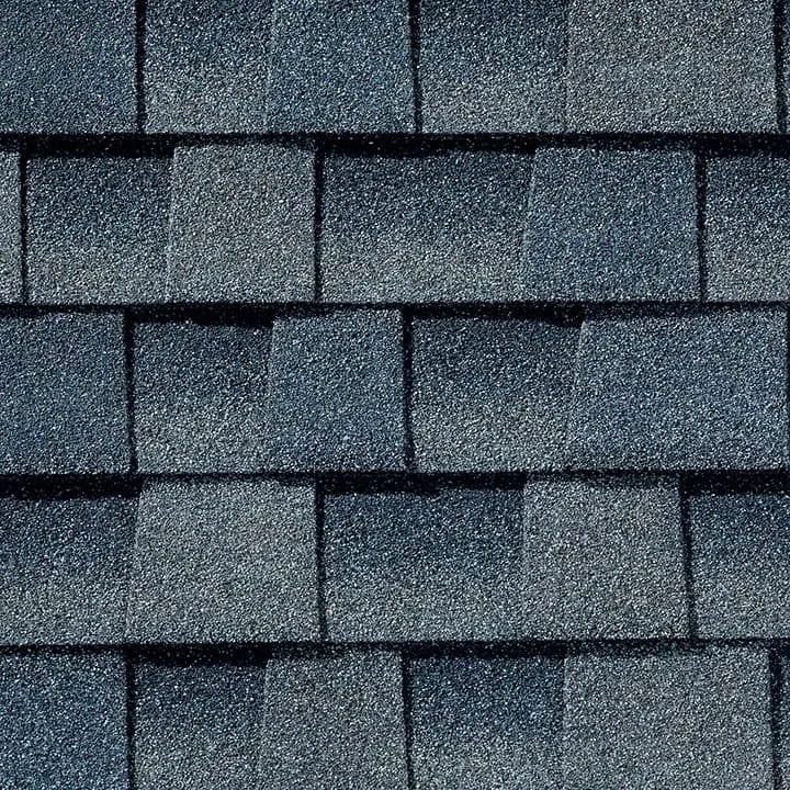 Close-up of a shingled roof with dark gray asphalt shingles.