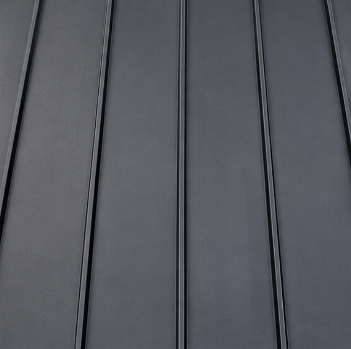 Close-up of a dark gray metal wall with vertical panels.