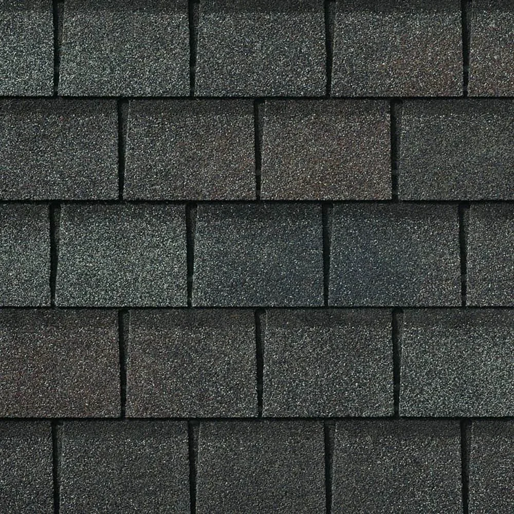 Close-up of black asphalt roof shingles with a textured surface arranged in horizontal rows.