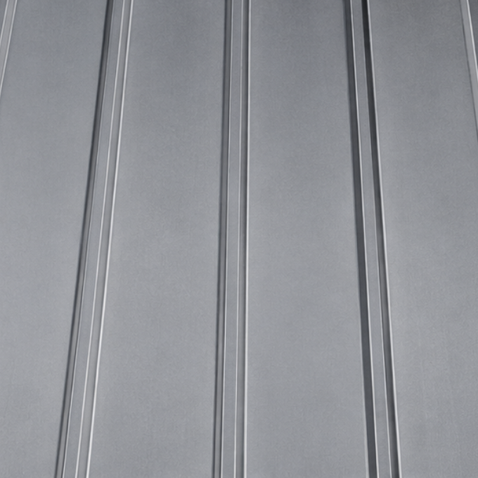 Close-up of a metallic metal roof with parallel ridges.