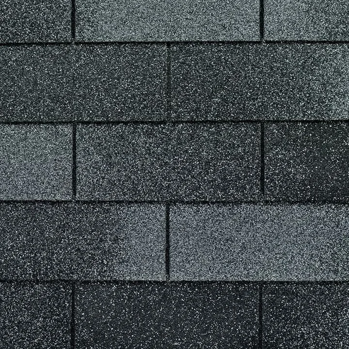 Close-up of a section of textured asphalt shingles.