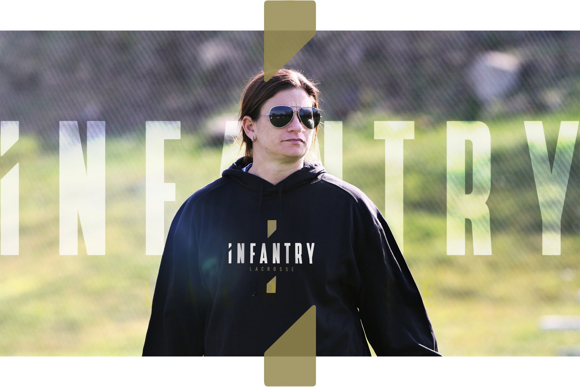 Person wearing sunglasses and an 'Infantry Lacrosse' hoodie, standing outdoors with a blurred background featuring green grass.