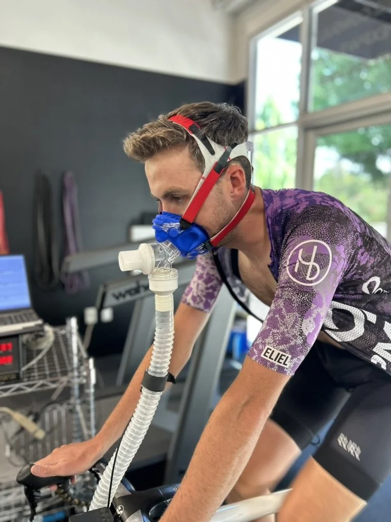 A young man wearing a cycling jersey marked with 'ELIEL' and a