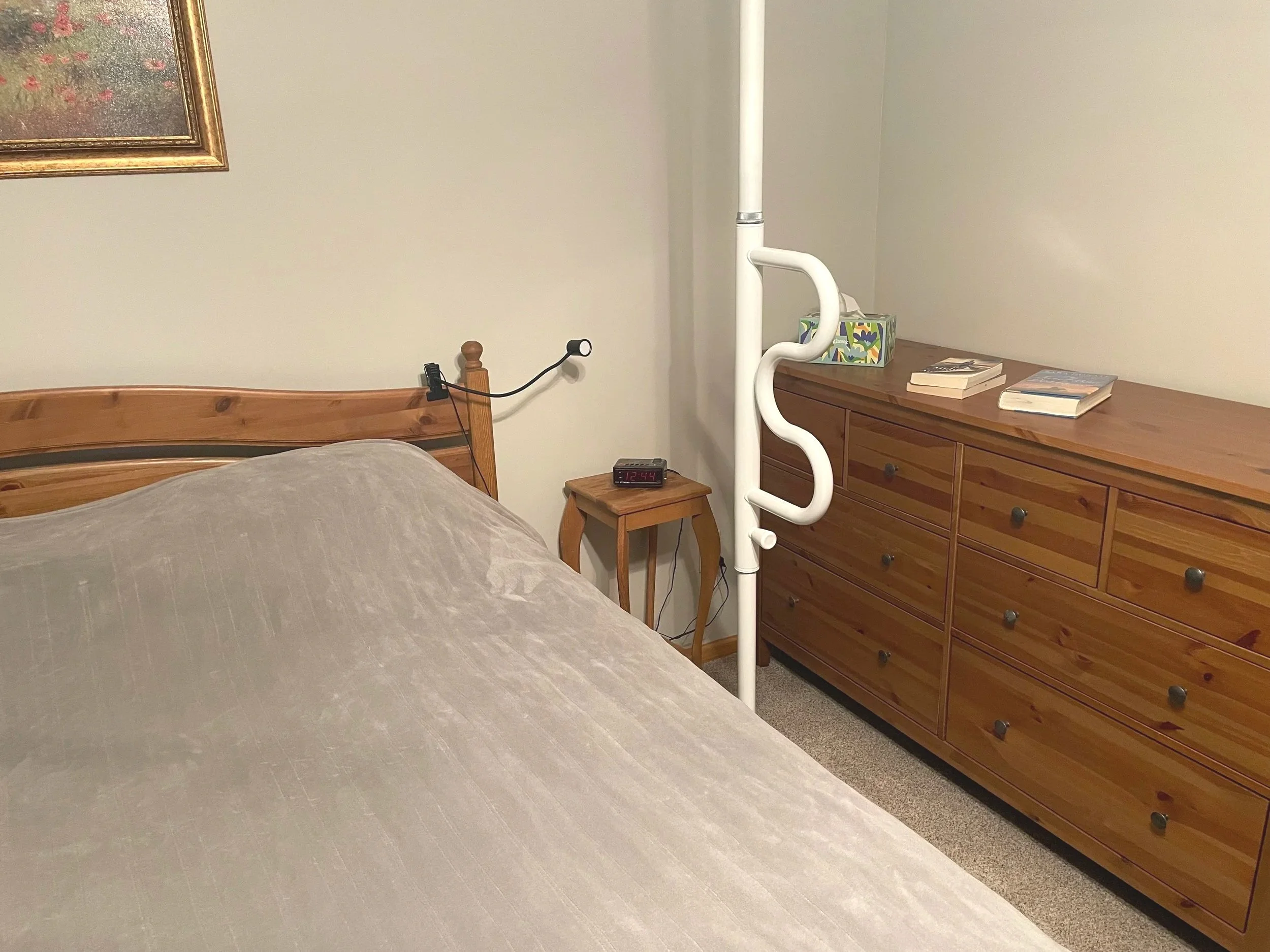 Long grab bar by bed to help with standing and stability