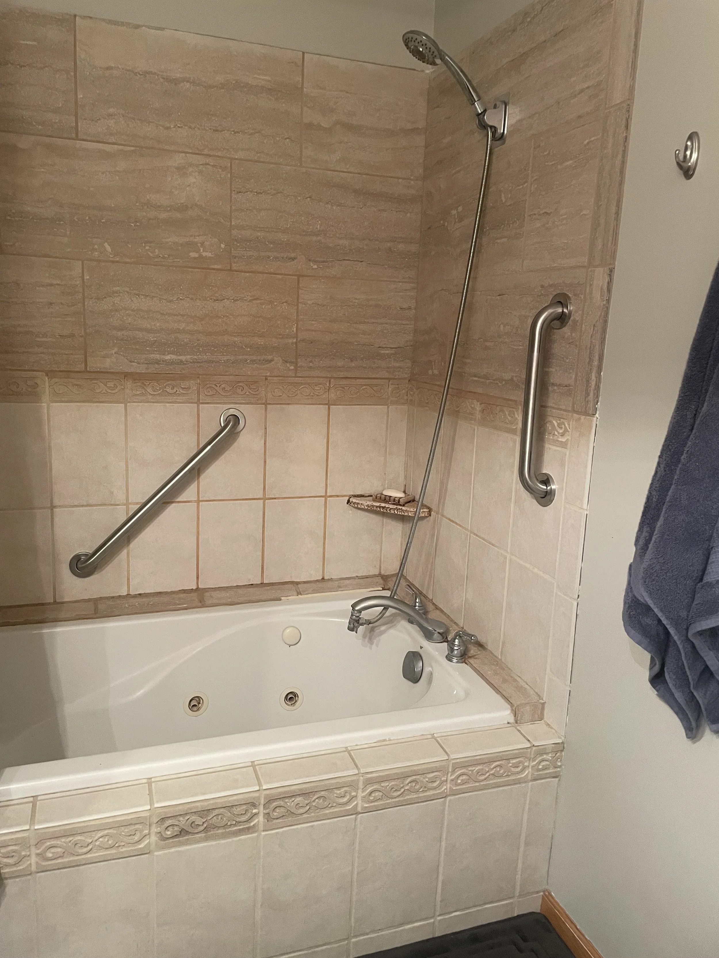 Angled grab bar in bathtub for stability while bathing