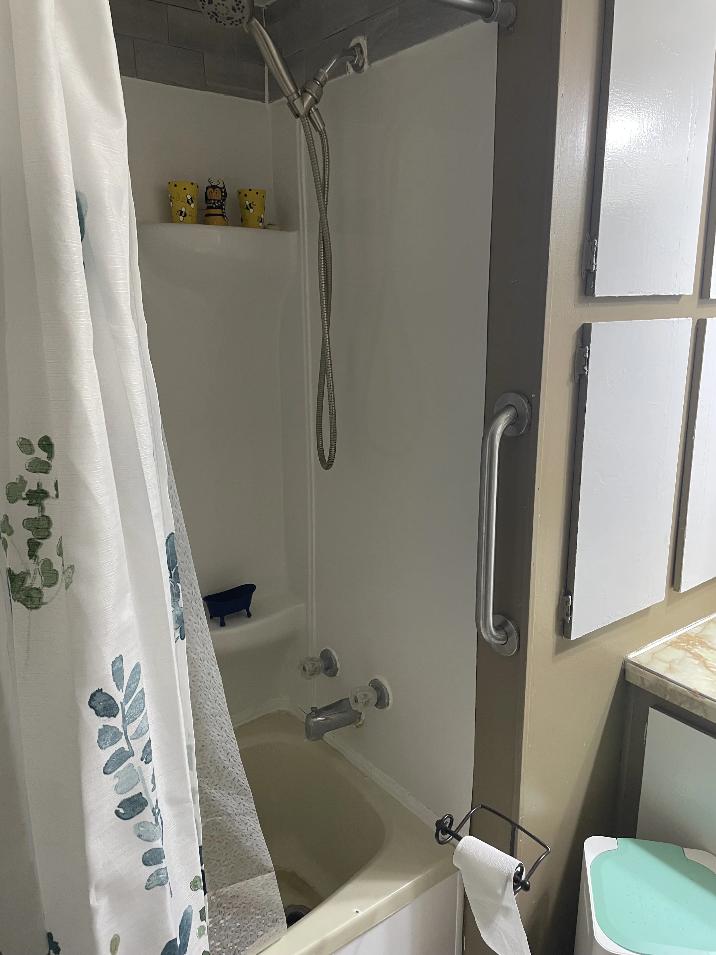 Vertical grab bar in shower for safe entry and exit