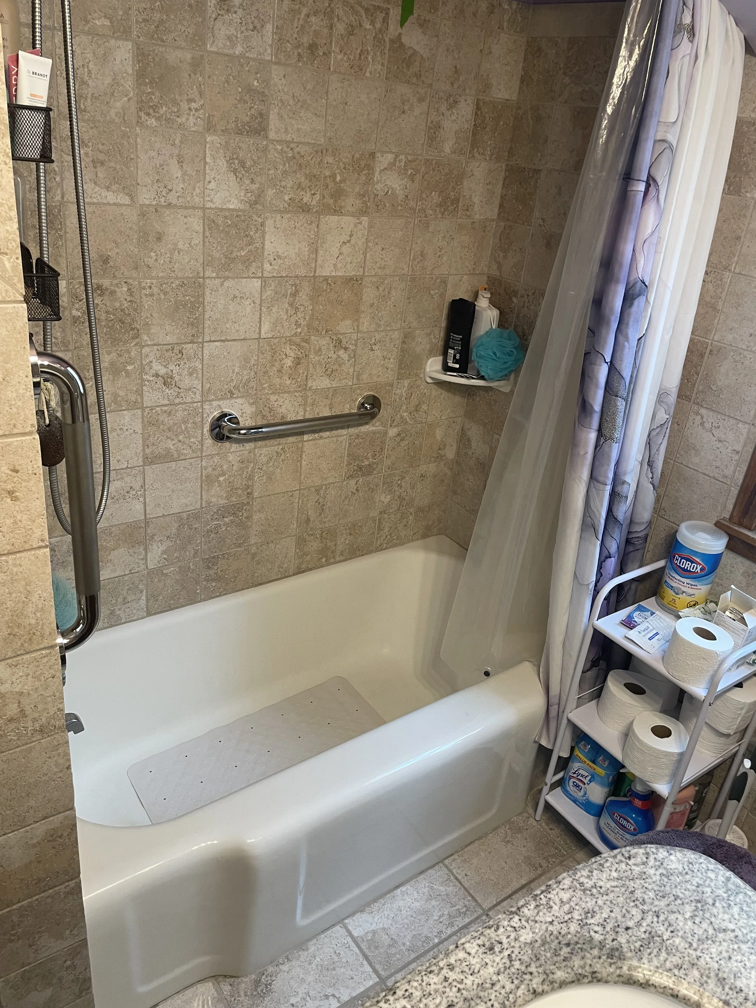 Vertical grab bar in shower for safe entry and exit
