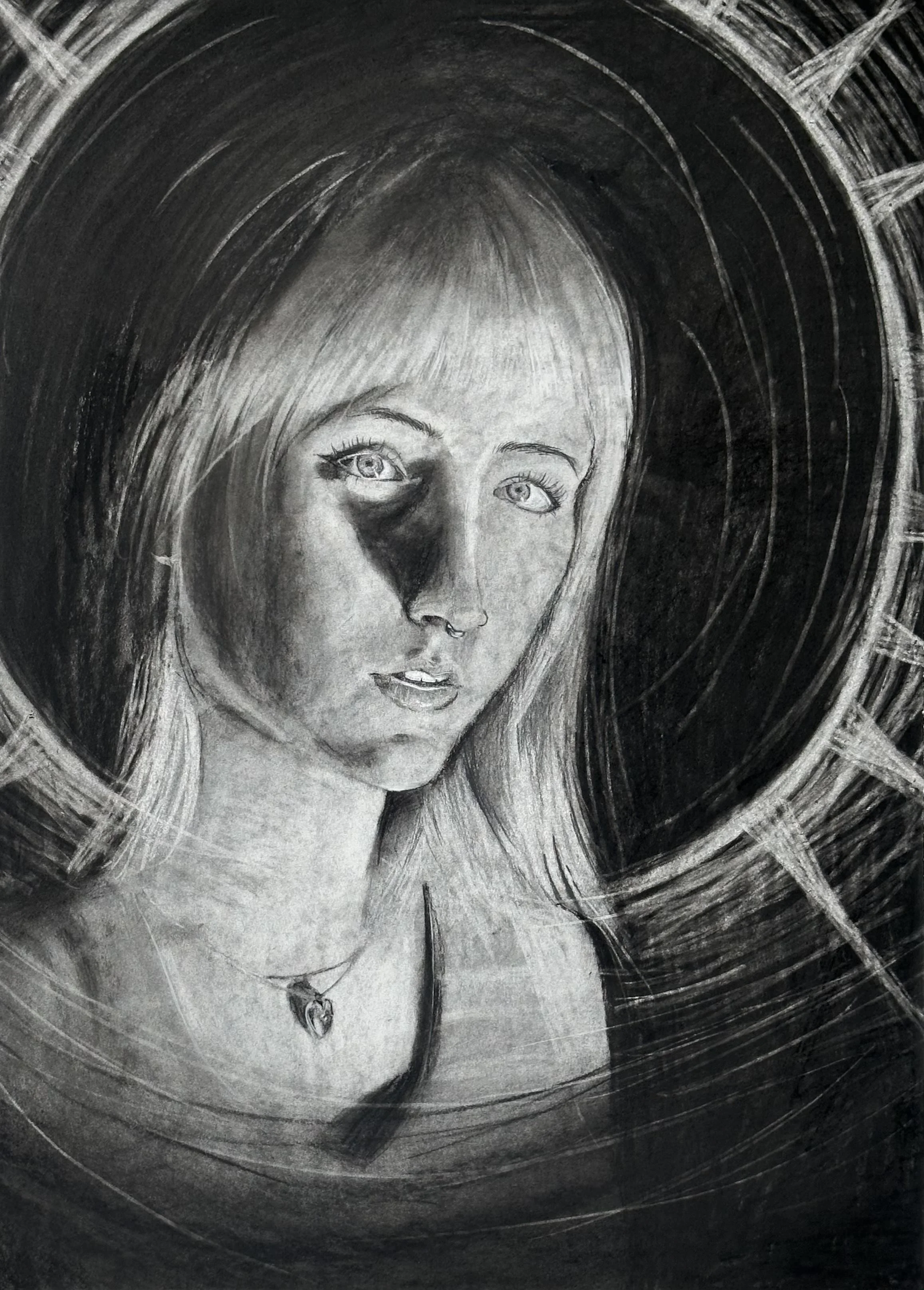 Charcoal drawing of a woman with long hair, gazing forward. She is framed by a dark halo-like circle, creating a mysterious, contemplative mood.
