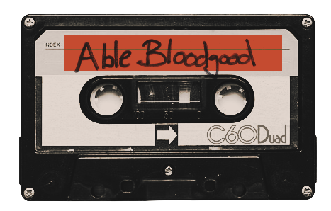 A cassette tape labeled 'Able Bloodgood' in red marker with a white background and black casing.