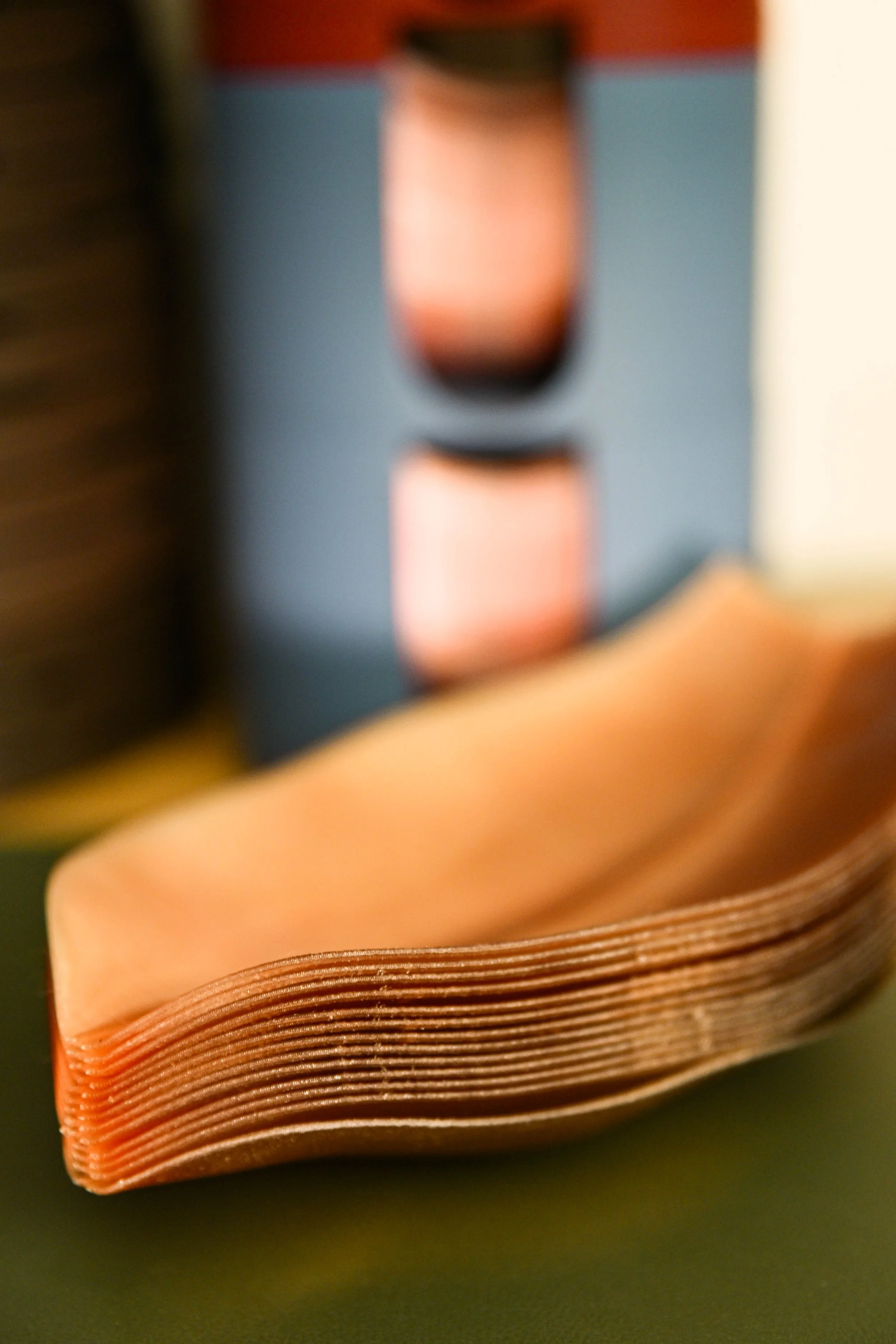 A close-up view of a stack of shade of fLumina with a blurred background.